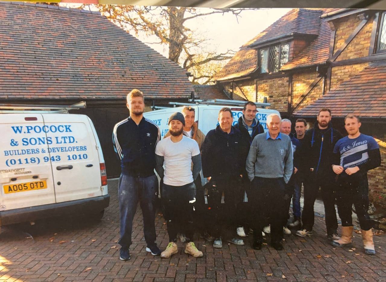 The W. Pocock & Sons team with the company vans