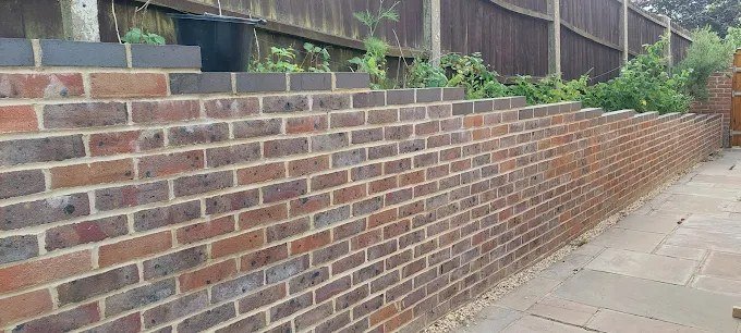 A brick retaining wall built by W. Pocock & Sons