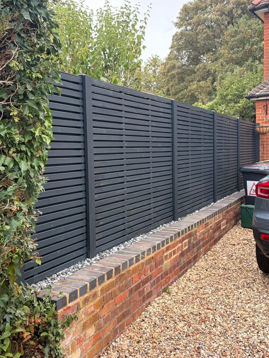 Slatted fencing on a brick wall, built by W. Pocock & Sons