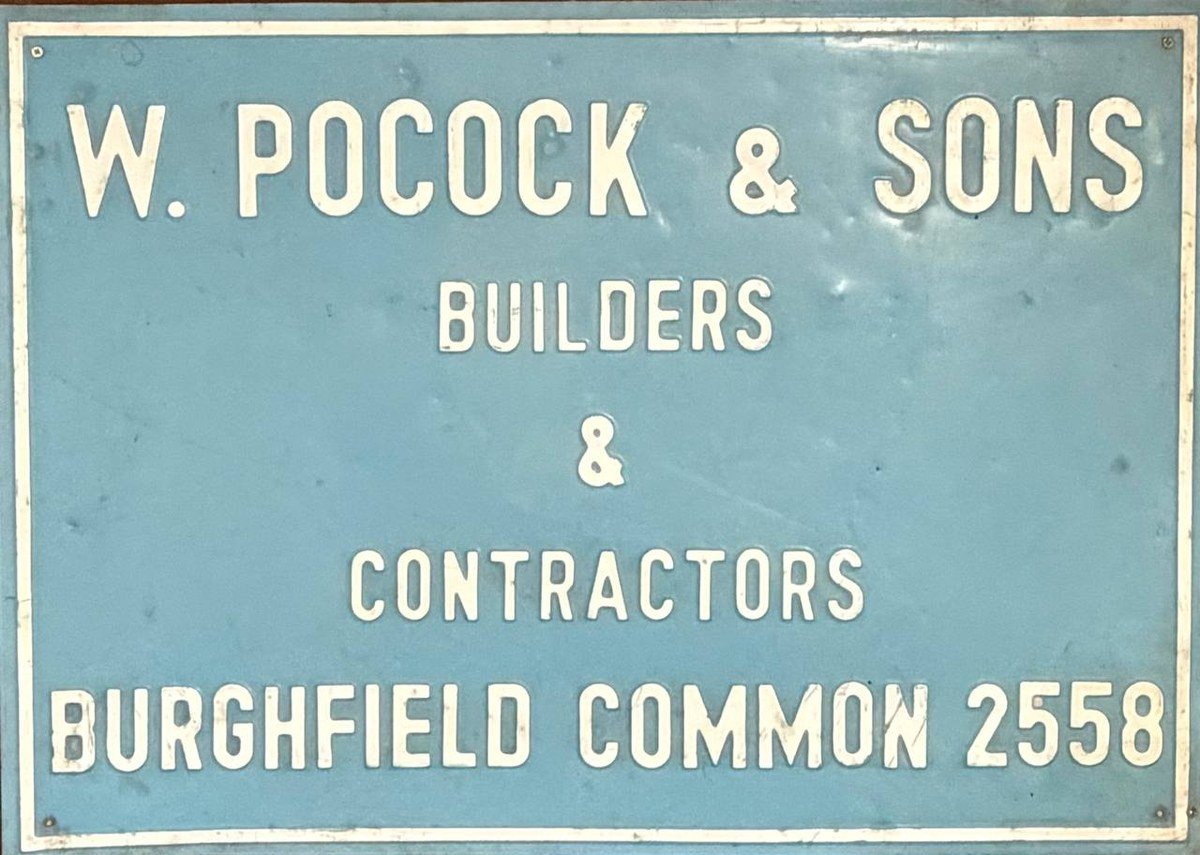 The firm's site board from the 1970s, reading W. Pocock & Sons, Builders & Contractors, Burghfield Common 2558